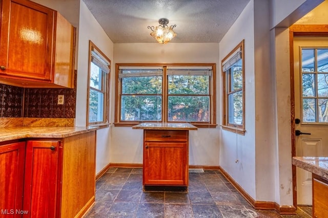 kitchen featuring decorative backsplash and a textured ceiling