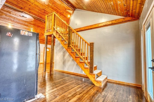 stairs featuring lofted ceiling, wood ceiling, and wood-type flooring