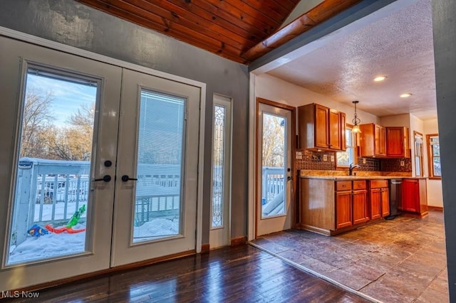 entryway with french doors, sink, wood-type flooring, a textured ceiling, and wooden ceiling