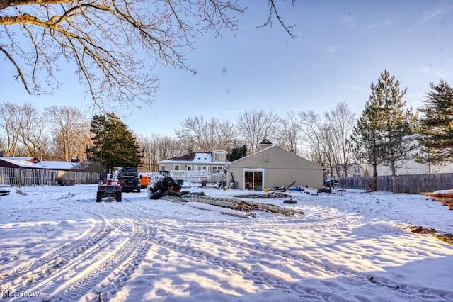 view of snow covered back of property