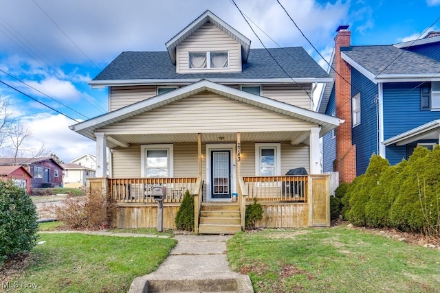 view of front of home with a porch and a front yard