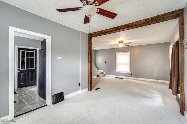 2743 12th St SW, Canton, OH 44710 - carpeted spare room featuring a ceiling fan, stairs, baseboards, and beamed ceiling