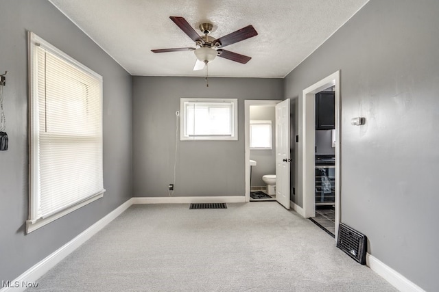 2743 12th St SW, Canton, OH 44710 - spare room featuring light carpet, a textured ceiling, baseboards, and ceiling fan