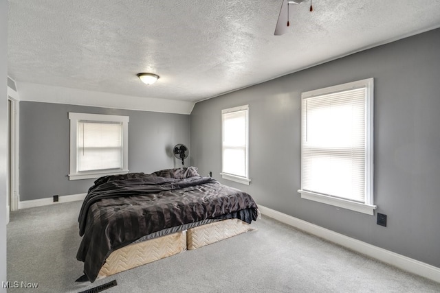 2743 12th St SW, Canton, OH 44710 - carpeted bedroom with a textured ceiling, baseboards, and a ceiling fan