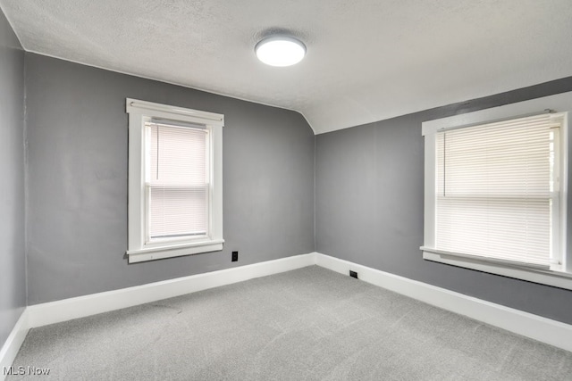2743 12th St SW, Canton, OH 44710 - empty room with carpet flooring, lofted ceiling, baseboards, and a textured ceiling