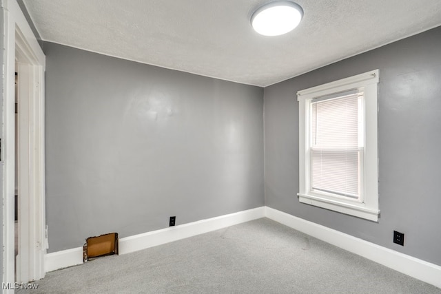 2743 12th St SW, Canton, OH 44710 - spare room featuring carpet floors, a textured ceiling, and baseboards