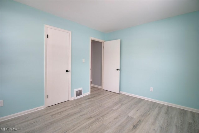 unfurnished bedroom featuring light wood-type flooring