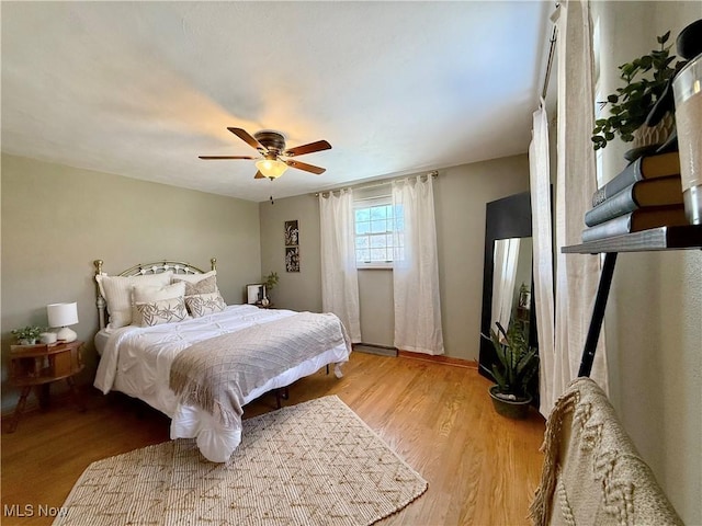 bedroom featuring a ceiling fan and wood finished floors