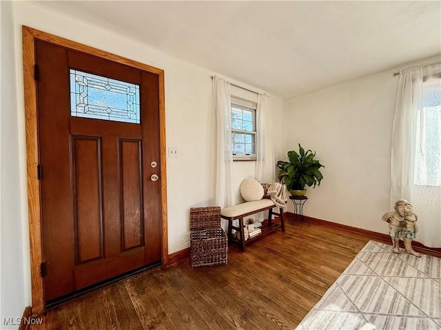 foyer featuring dark wood-style floors and baseboards