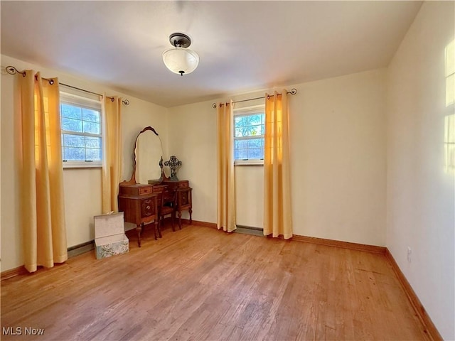 bedroom with light wood-style flooring and baseboards