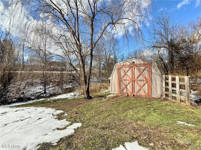 snow covered structure featuring a lawn