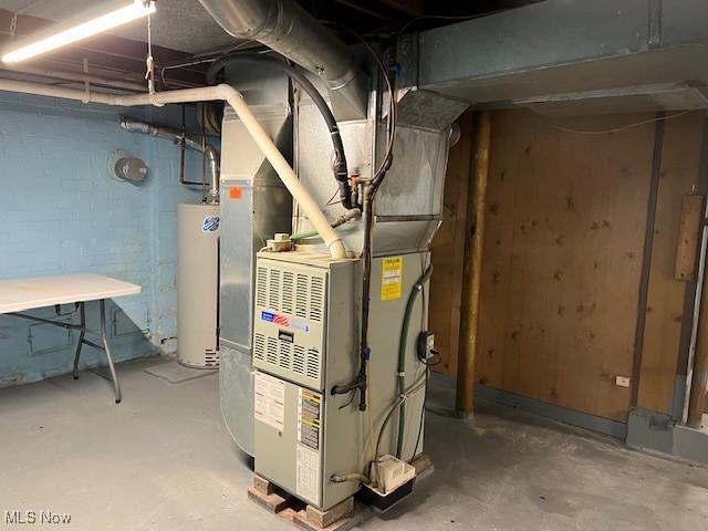 utility room with heating unit and gas water heater