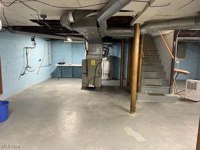 basement featuring heating unit, electric panel, and water heater