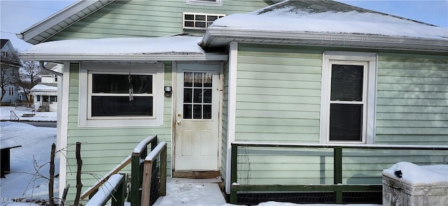 view of snow covered property entrance