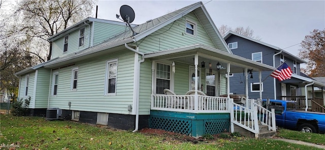 back of property featuring cooling unit, a lawn, and a porch