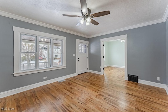 entryway with crown molding, ceiling fan, a textured ceiling, and light hardwood / wood-style floors