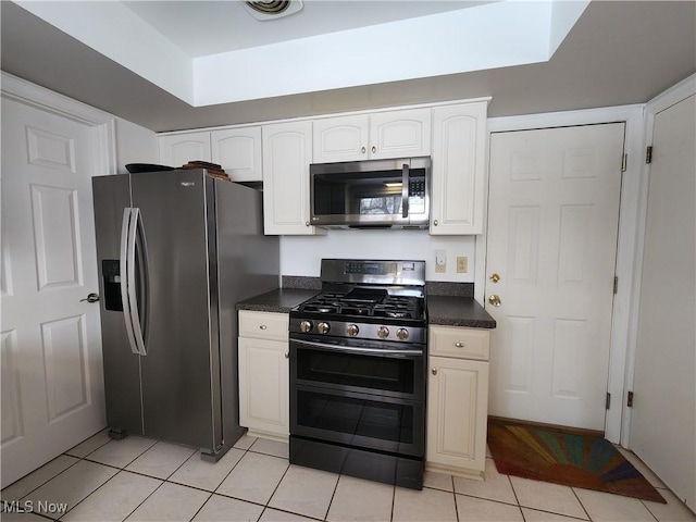 kitchen featuring light tile patterned floors, white cabinets, and appliances with stainless steel finishes