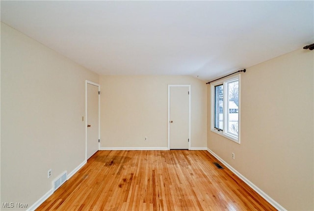 spare room with light hardwood / wood-style flooring