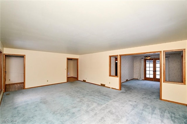 carpeted spare room with french doors