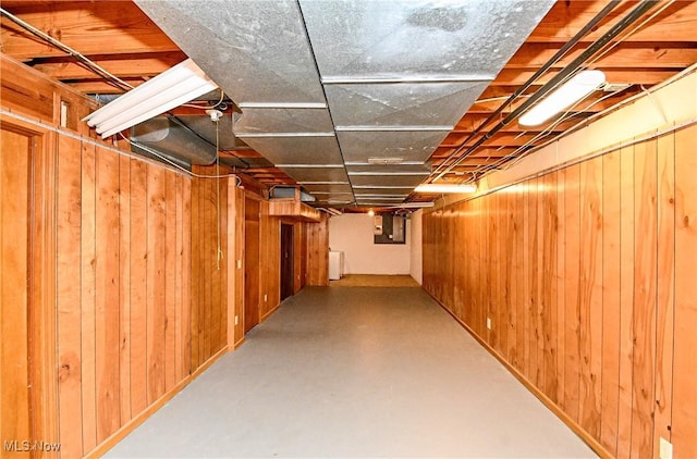 basement with washer / dryer and wooden walls