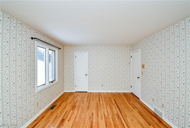 empty room with wood-type flooring