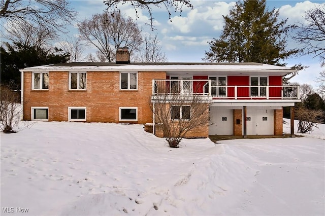 snow covered property featuring a balcony