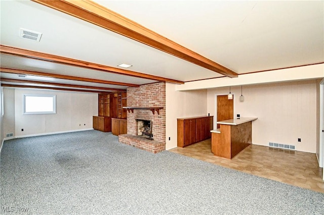 unfurnished living room with beam ceiling, a fireplace, and light colored carpet