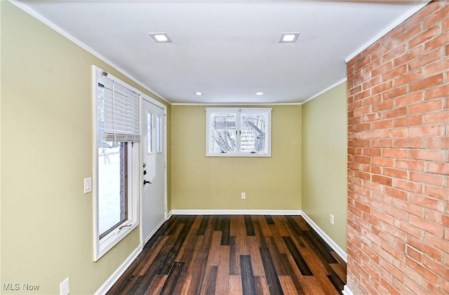 entrance foyer with dark hardwood / wood-style flooring and ornamental molding