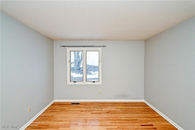 unfurnished room with light hardwood / wood-style floors