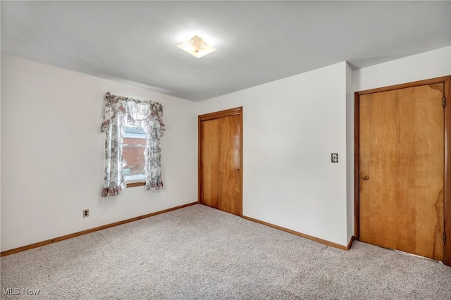 unfurnished room with light carpet