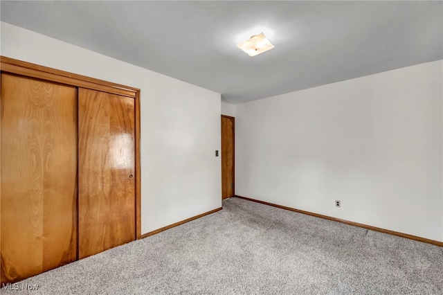 unfurnished bedroom with carpet floors and a closet