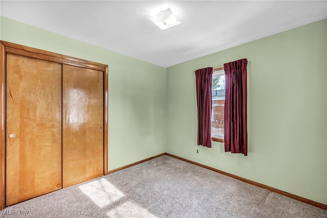 unfurnished bedroom featuring carpet flooring and a closet