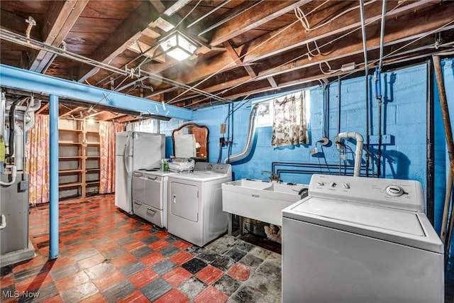 clothes washing area with sink and washer and clothes dryer