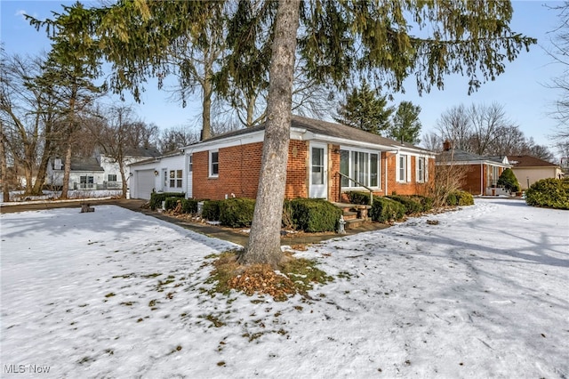 view of snowy exterior with a garage