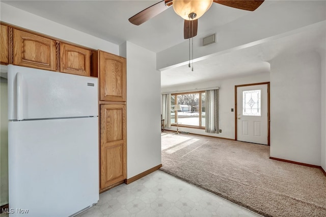 kitchen with light colored carpet, ceiling fan, and white fridge