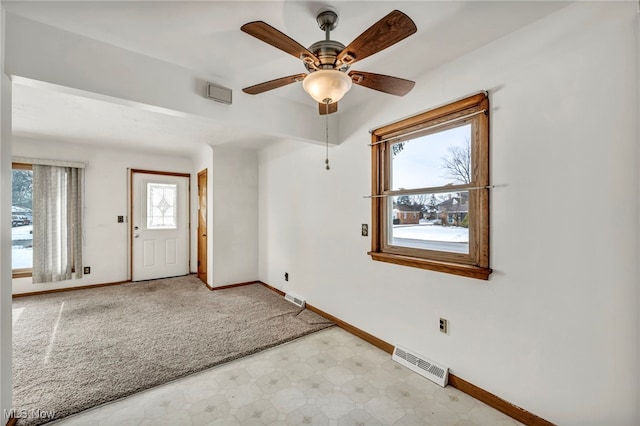 unfurnished room featuring ceiling fan and a healthy amount of sunlight