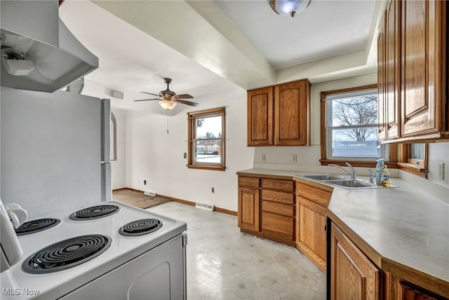 kitchen with white electric range oven, sink, island range hood, fridge, and ceiling fan