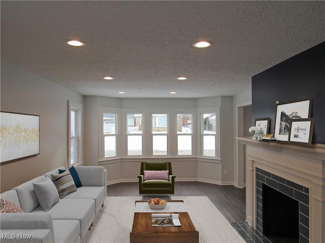 living room with dark hardwood / wood-style flooring and a textured ceiling