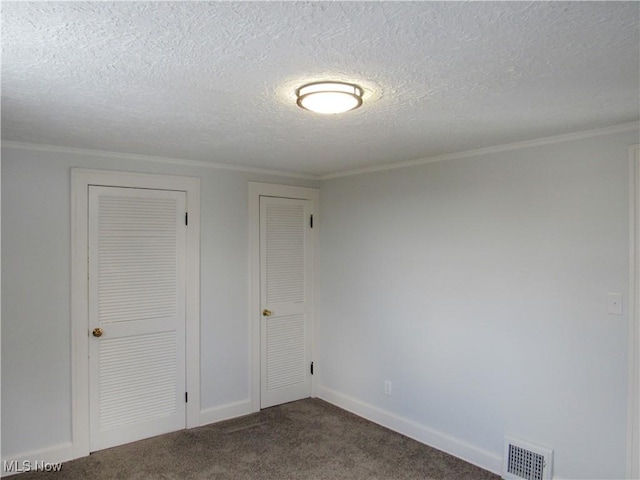 unfurnished bedroom featuring ornamental molding, carpet flooring, and a textured ceiling