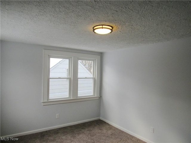 empty room featuring carpet flooring and a textured ceiling