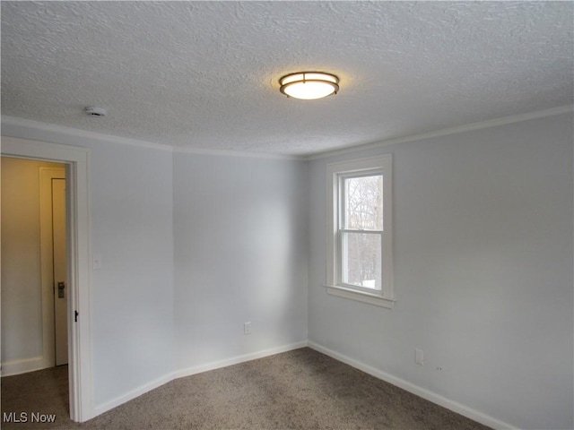 carpeted spare room with a textured ceiling