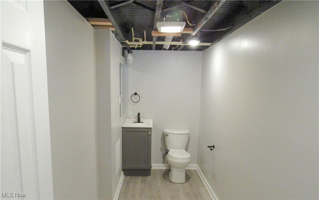 bathroom with vanity, hardwood / wood-style floors, and toilet