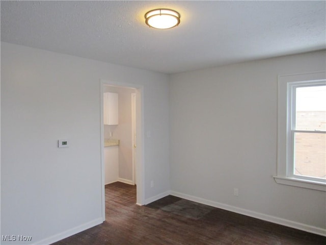 spare room featuring dark hardwood / wood-style floors