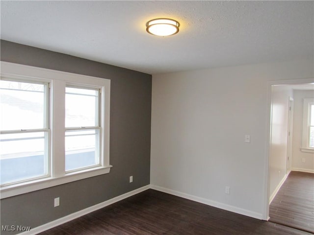 empty room featuring dark hardwood / wood-style flooring