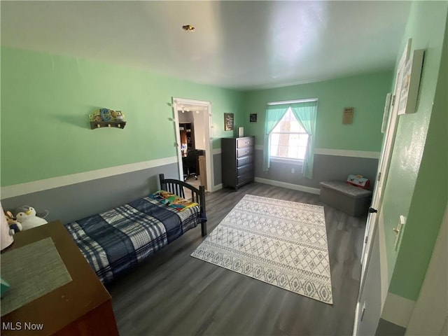 bedroom with wood-type flooring