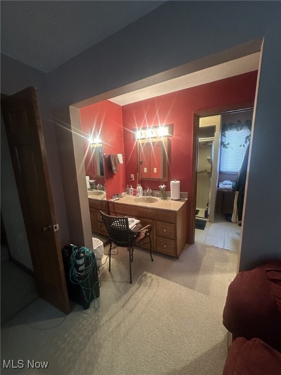 home office with light colored carpet and sink