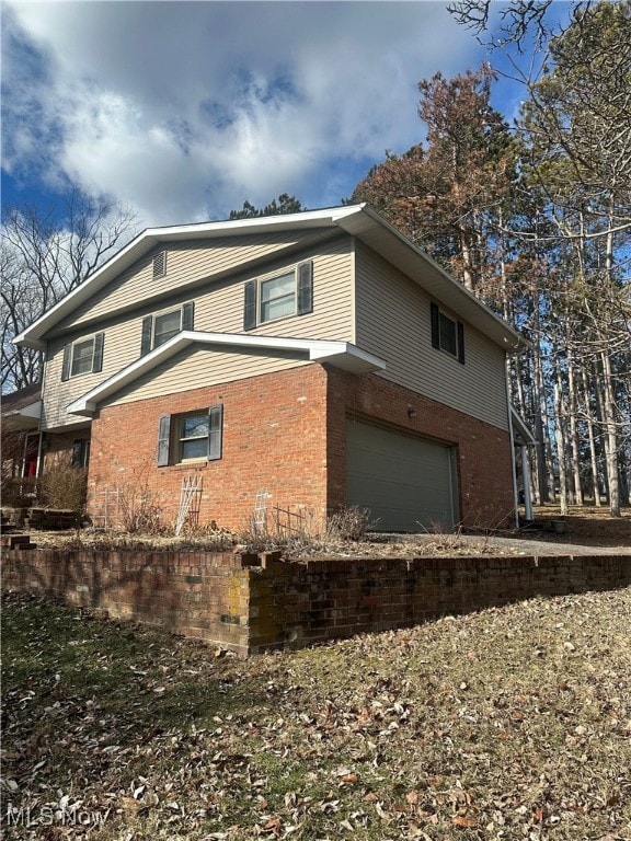 view of side of property with a garage