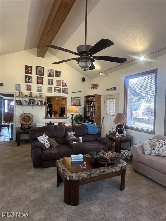 carpeted living room featuring vaulted ceiling with beams and ceiling fan