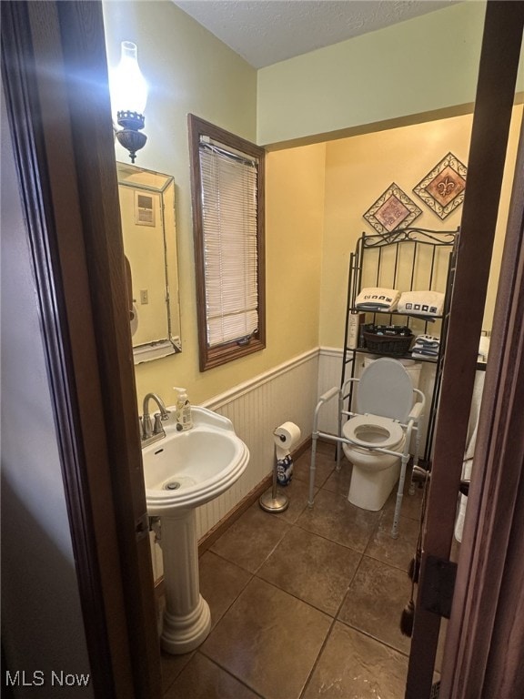 bathroom featuring tile patterned floors and toilet