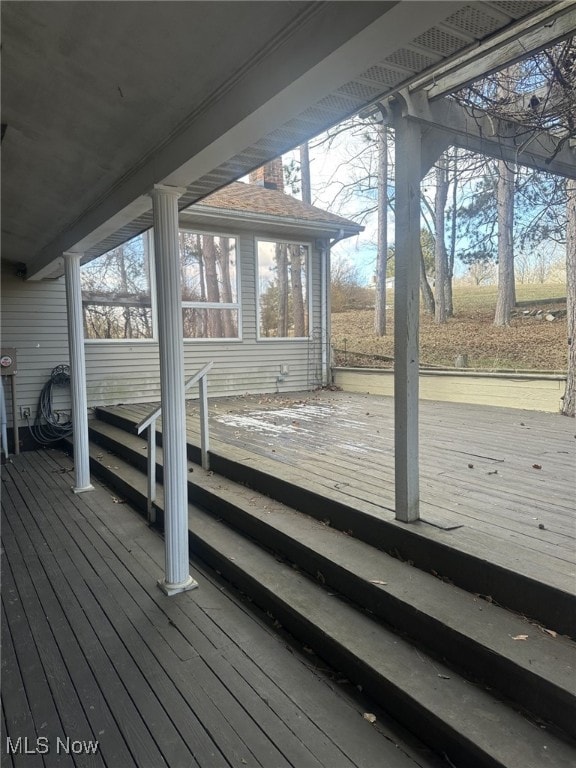 wooden deck with a sunroom